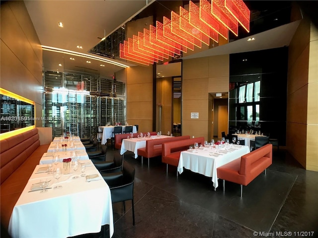 dining room with a high ceiling and expansive windows