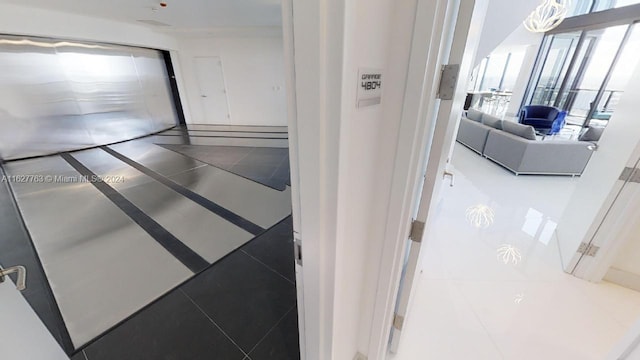 hallway with tile patterned floors