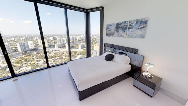 bedroom featuring floor to ceiling windows and tile patterned floors