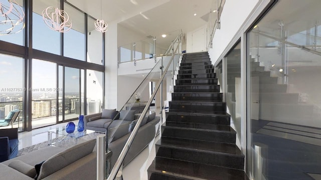 stairs featuring a towering ceiling