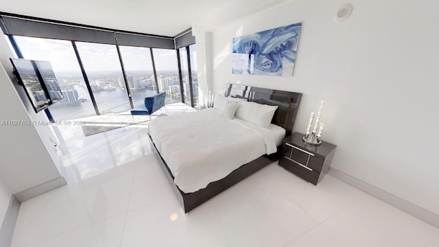 bedroom featuring tile patterned flooring and expansive windows