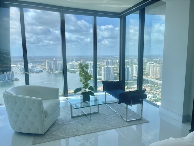 living area featuring a wall of windows, tile patterned flooring, and plenty of natural light