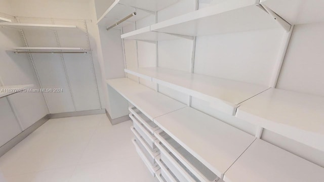 spacious closet featuring light tile patterned floors