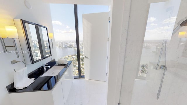 bathroom with vanity, a water view, and tile patterned flooring