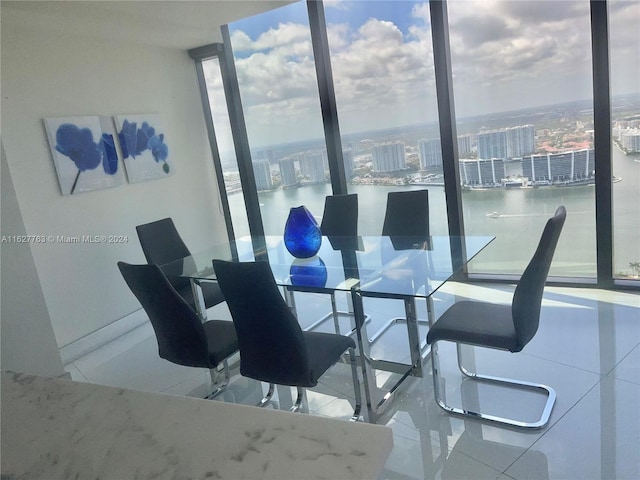 tiled dining space with a water view and a wall of windows