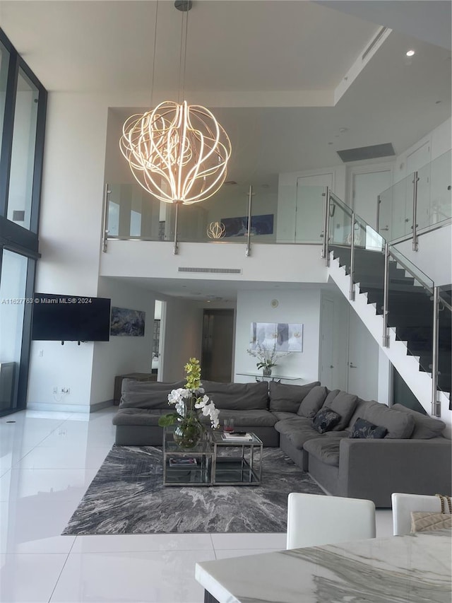 interior space with a high ceiling, a chandelier, and tile patterned floors