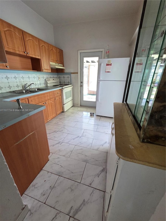 kitchen with a sink, tasteful backsplash, white appliances, marble finish floor, and under cabinet range hood