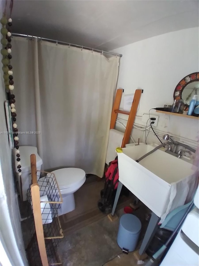 bathroom featuring toilet and a sink