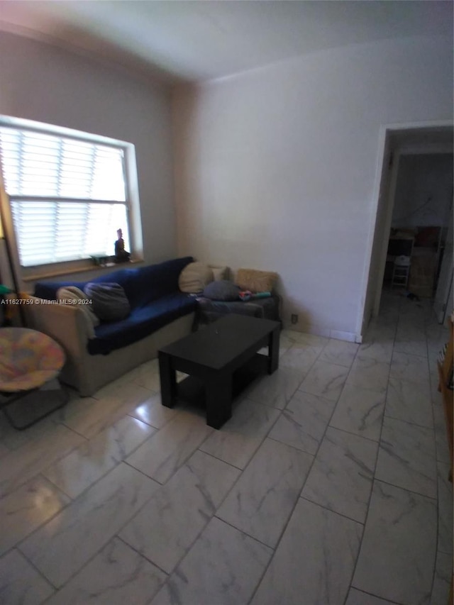 living area featuring marble finish floor