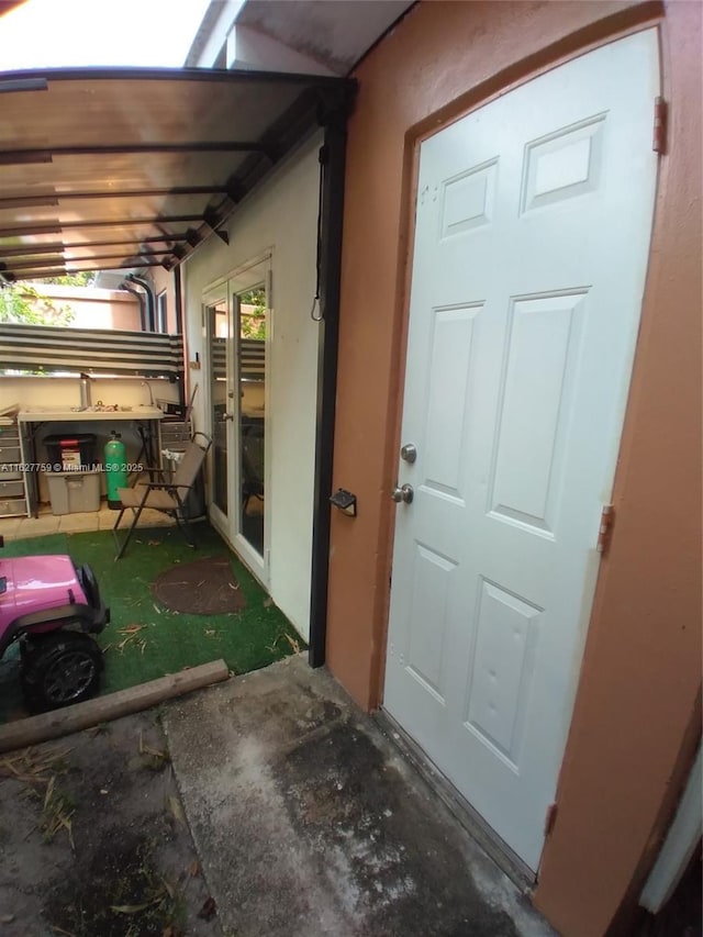 property entrance with stucco siding