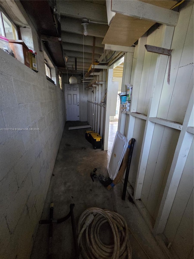 below grade area featuring concrete block wall
