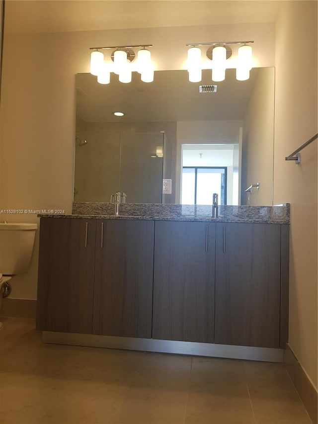 bathroom featuring sink, tile patterned floors, and toilet