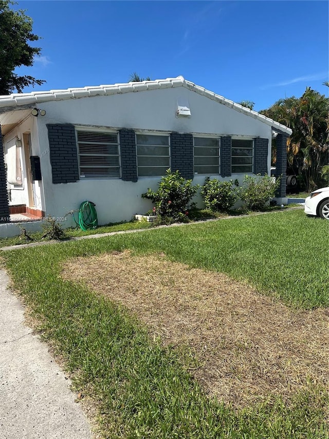 view of property exterior featuring a lawn