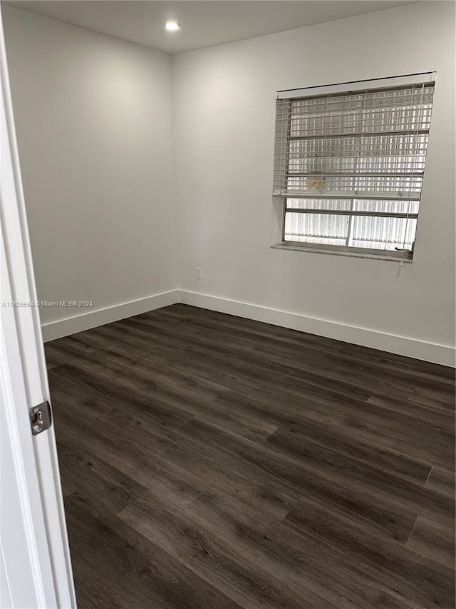 empty room with dark hardwood / wood-style floors