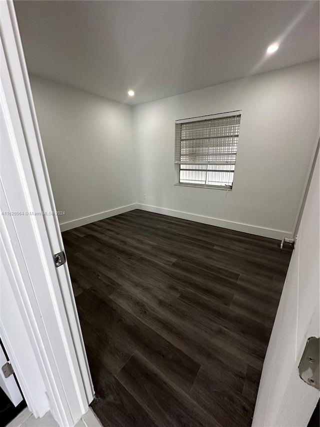 spare room featuring dark hardwood / wood-style flooring