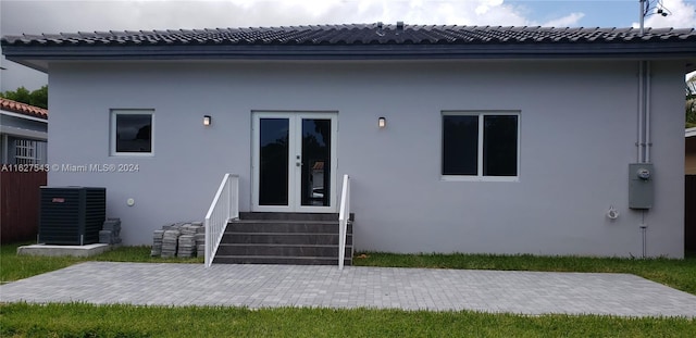 rear view of property featuring french doors and a patio