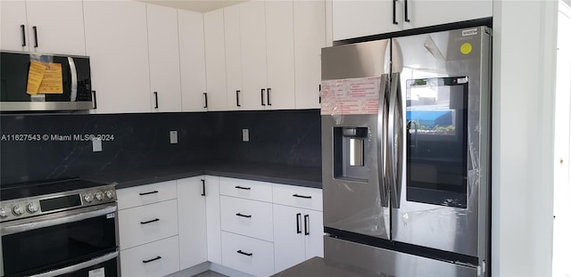 kitchen with decorative backsplash, white cabinetry, and appliances with stainless steel finishes