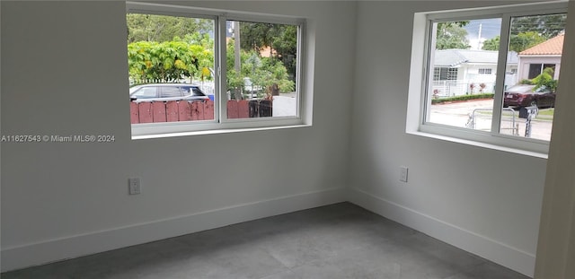 spare room featuring concrete flooring