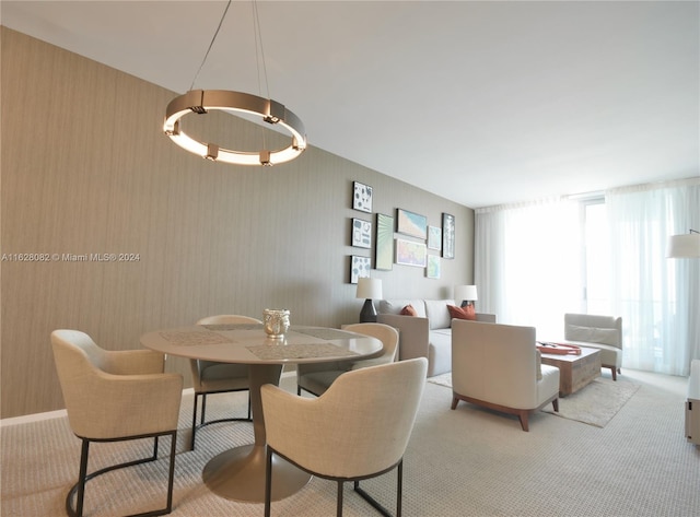 dining space featuring light colored carpet