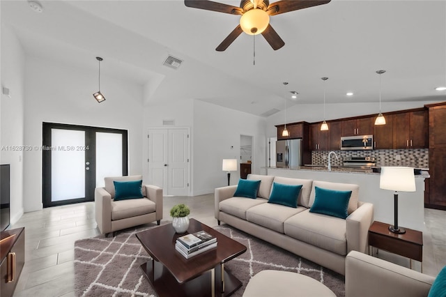 living room featuring vaulted ceiling, sink, and ceiling fan