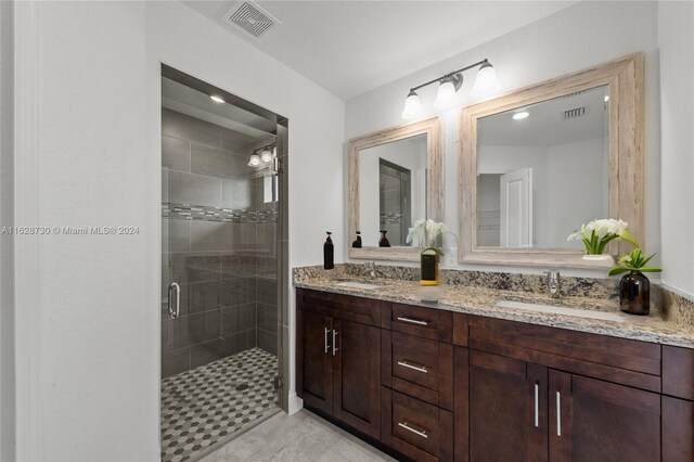 bathroom with vanity and a shower with shower door