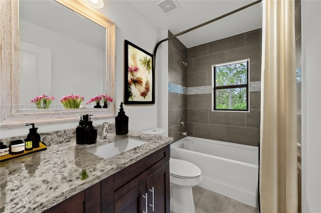 full bathroom with tile patterned flooring, vanity, shower / tub combo with curtain, and toilet