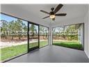 unfurnished sunroom with ceiling fan