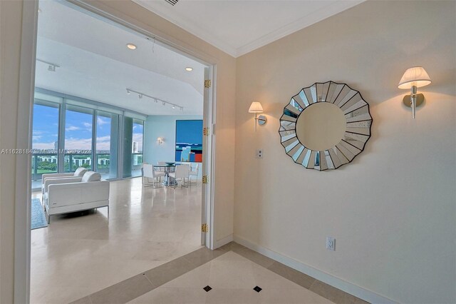 hallway featuring track lighting and light tile patterned floors