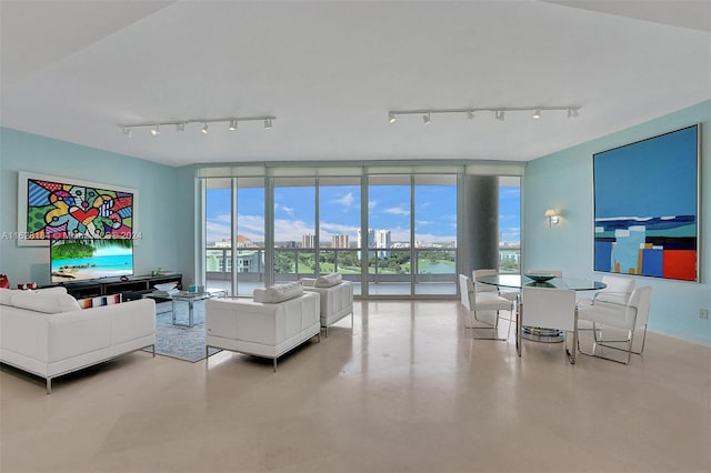 living room featuring floor to ceiling windows and track lighting