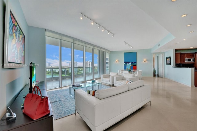 living room with track lighting and floor to ceiling windows