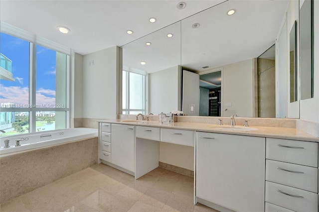 bathroom with tiled tub, tile patterned floors, and double sink vanity