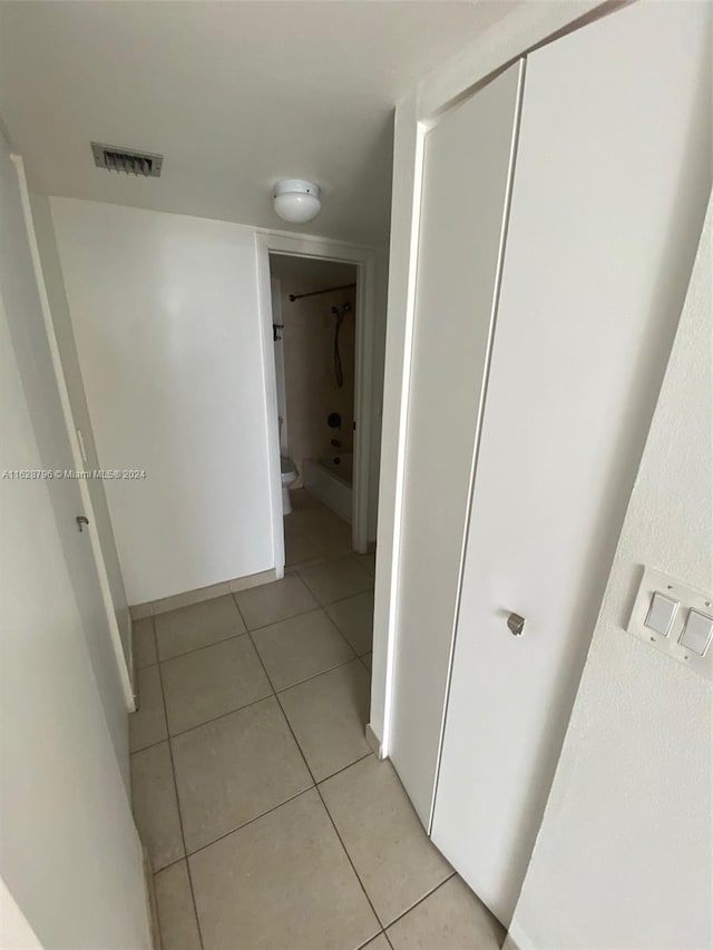 corridor featuring light tile patterned flooring