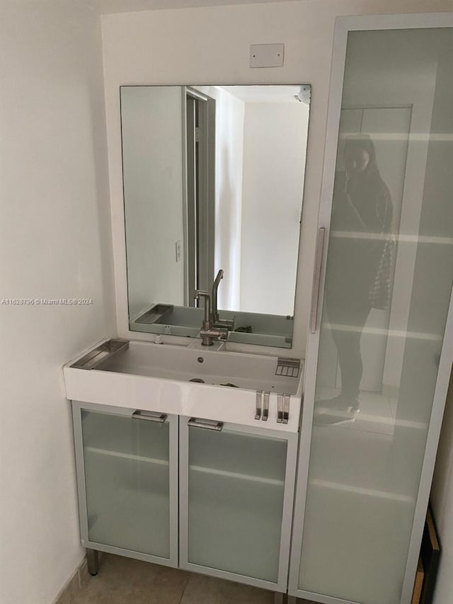 bathroom featuring tile patterned flooring and vanity