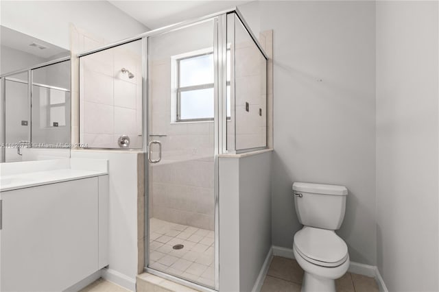 bathroom featuring tile patterned flooring, an enclosed shower, vanity, and toilet