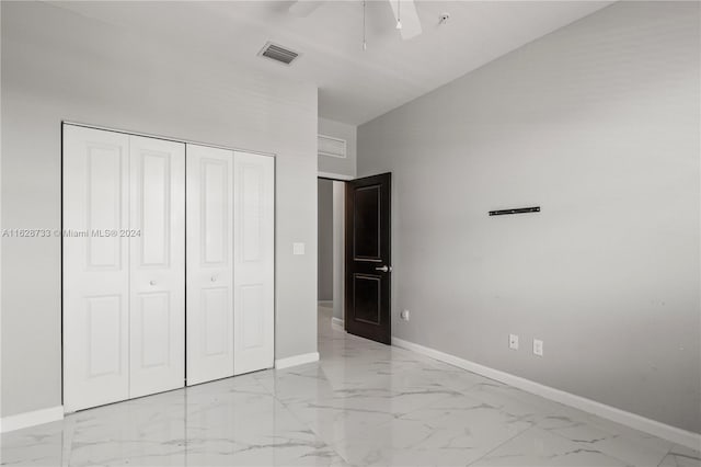 unfurnished bedroom with a closet, vaulted ceiling, and ceiling fan