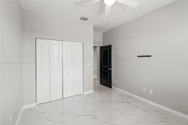 unfurnished bedroom featuring a closet, lofted ceiling, and ceiling fan