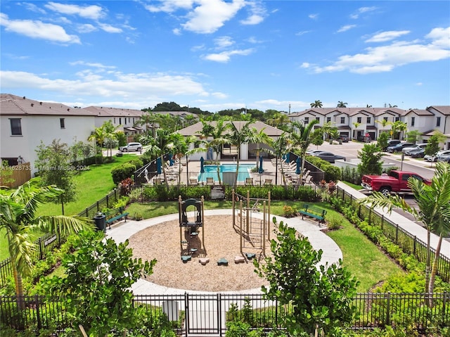 view of property's community with a pool and a yard