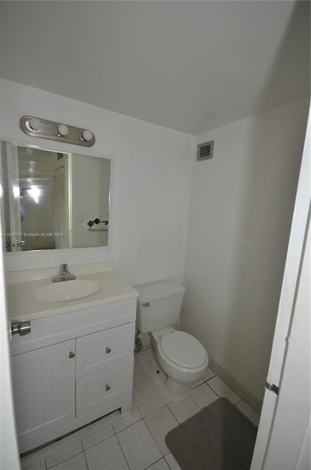 bathroom with tile patterned floors, vanity, and toilet