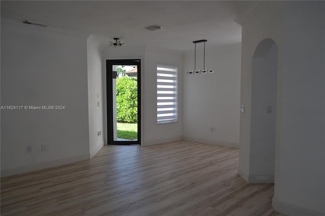 spare room with wood-type flooring and ornamental molding