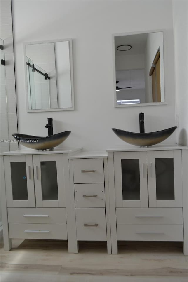 bathroom featuring wood-type flooring and double sink vanity