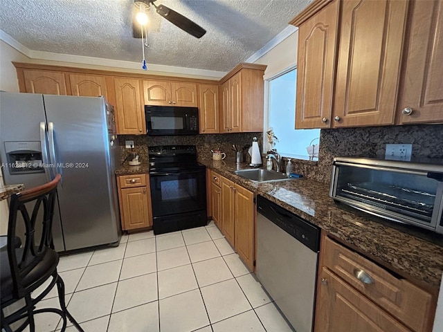 kitchen featuring dark stone counters, backsplash, ceiling fan, black appliances, and sink