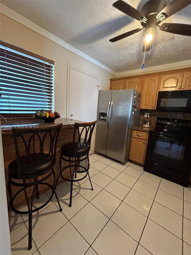 kitchen with black appliances, light tile patterned floors, a textured ceiling, ceiling fan, and ornamental molding