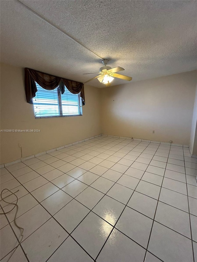 3600 NE 170th St Unit 411, North Miami Beach, FL 33160 - spare room with a ceiling fan, light tile patterned floors, and a textured ceiling