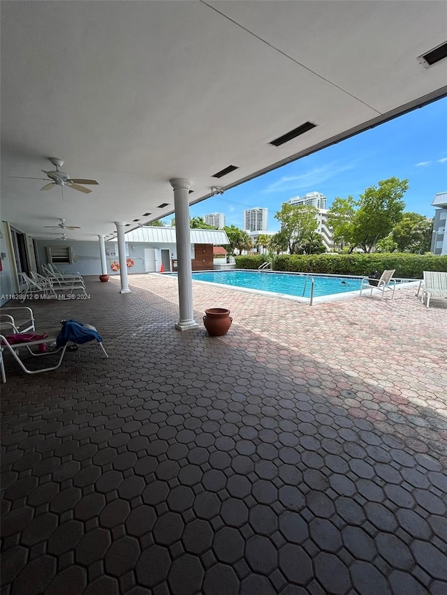 view of pool featuring ceiling fan and a patio area