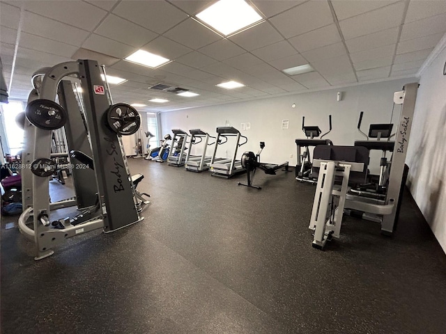 gym featuring a paneled ceiling