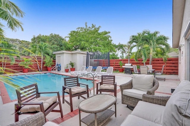 view of patio featuring a fenced in pool and outdoor lounge area