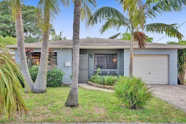 208 SW 2nd Ave, Hallandale Beach, FL 33009 - ranch-style home with a garage, brick siding, decorative driveway, and a front lawn