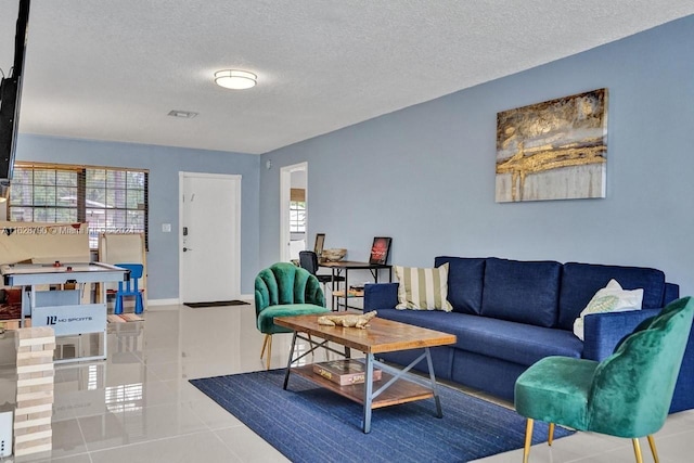 208 SW 2nd Ave, Hallandale Beach, FL 33009 - living area featuring healthy amount of natural light, a textured ceiling, and tile patterned flooring