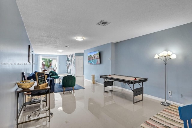 208 SW 2nd Ave, Hallandale Beach, FL 33009 - playroom featuring a textured ceiling and tile patterned floors