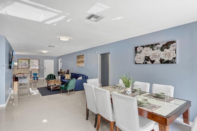 208 SW 2nd Ave, Hallandale Beach, FL 33009 - dining area with tile patterned flooring and a textured ceiling
